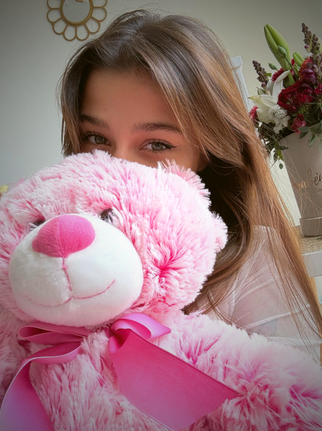 Pink teddy bear and flowers